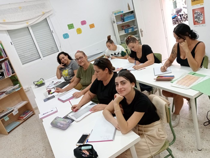 Women in a training class smiling at the camera