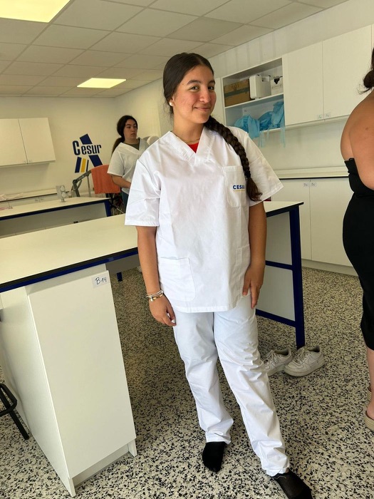 A student in a healthcare uniform in the training room